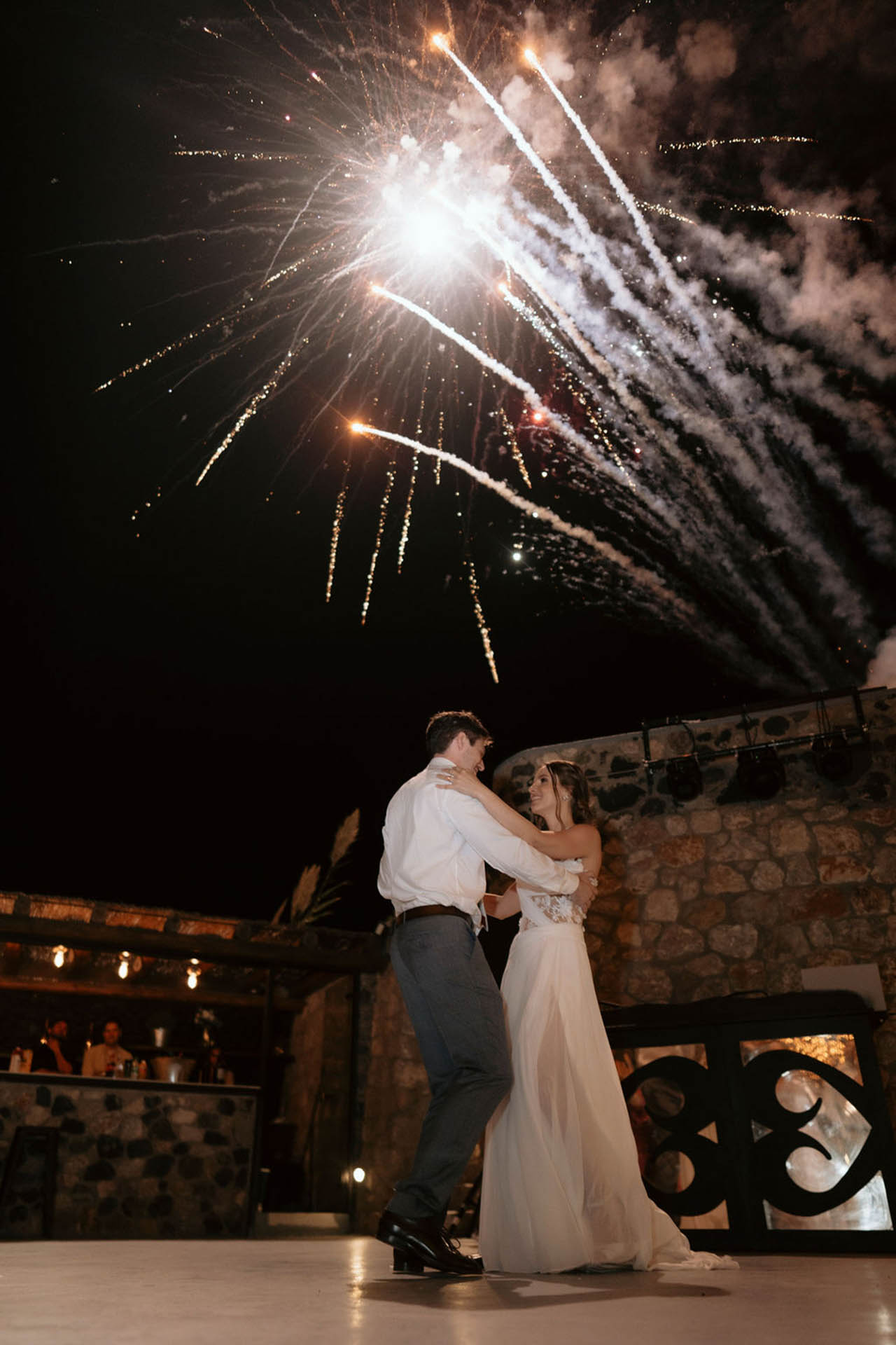 Magical first dance after the wedding under Santorini’s starlit sky and fireworks