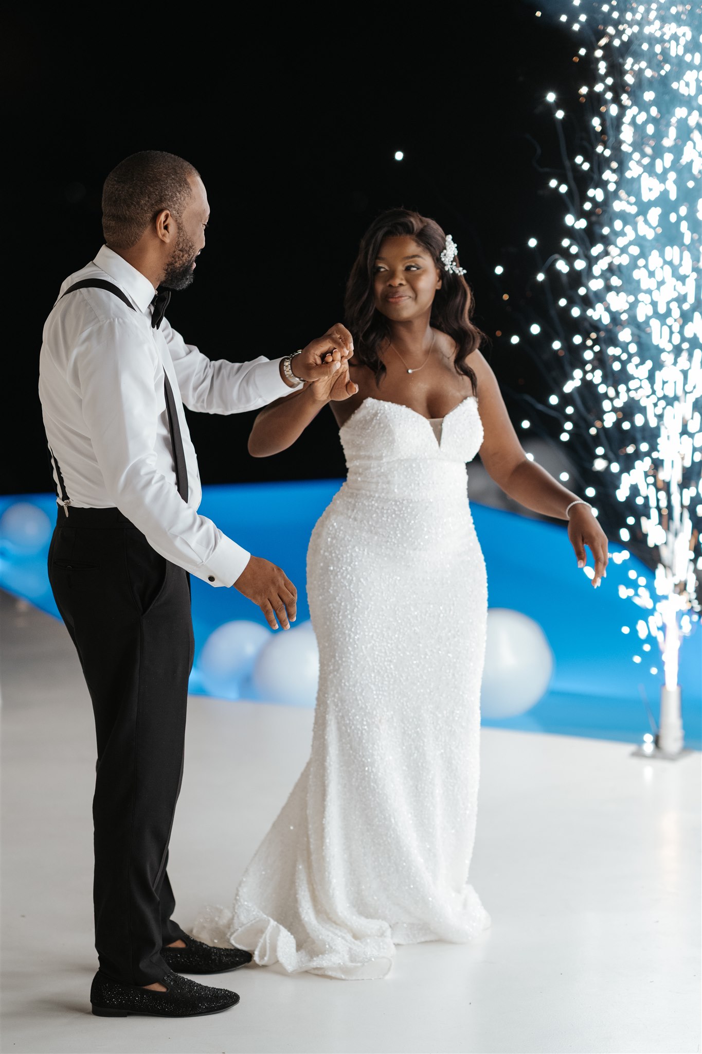 wedding at Dana Villas in Santorini - the couple in front of ground fireworks - Marvellous Wedding