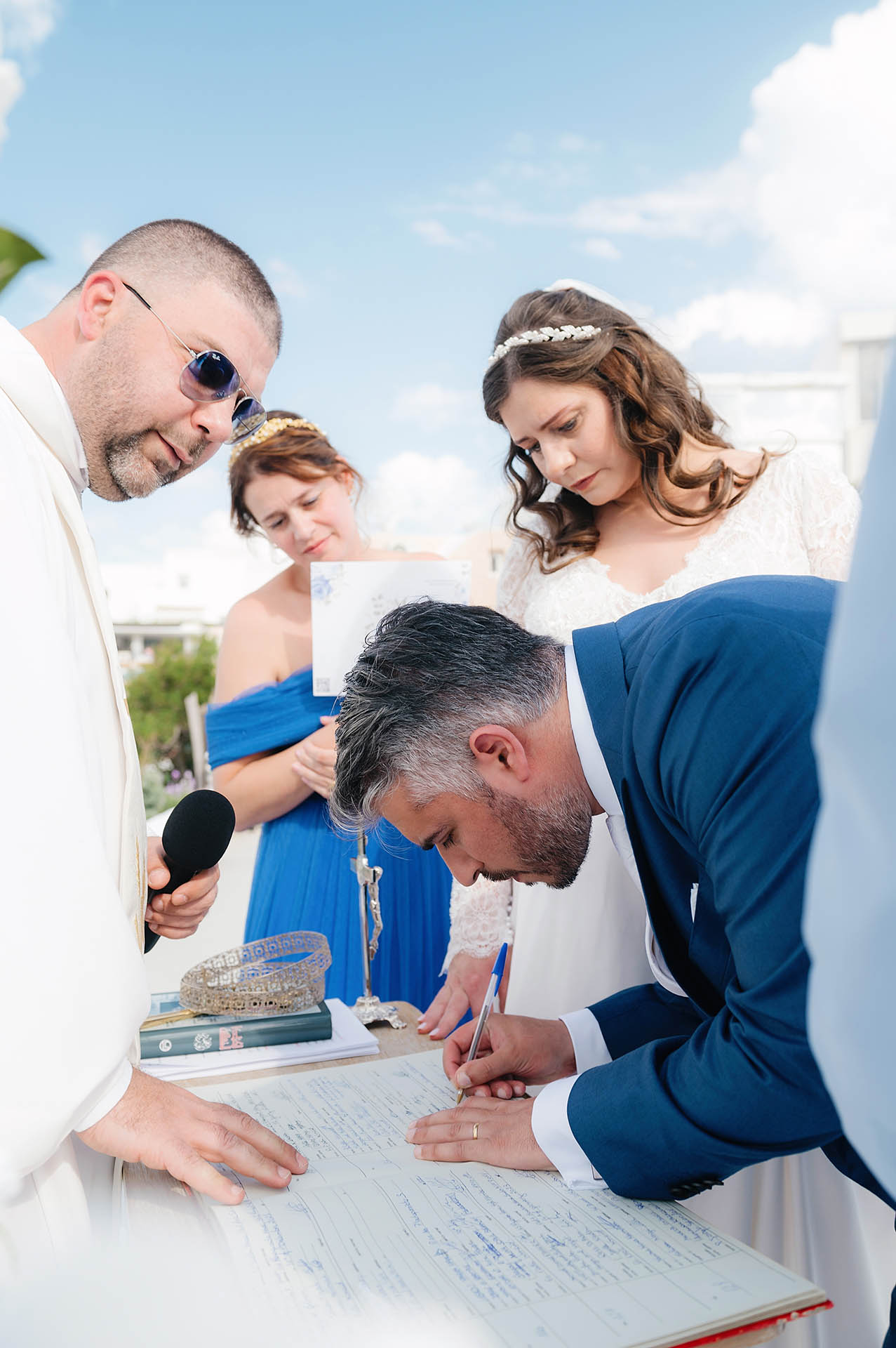 Legal Documents for a Santorini Wedding - groom sign the legal papers for the wedding - Marvellous wedding