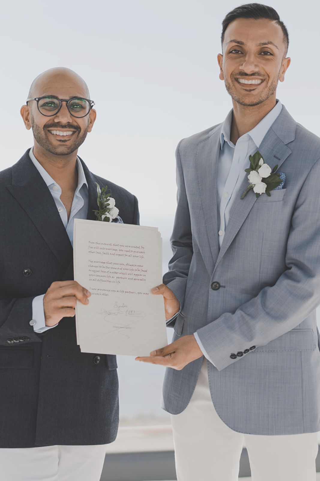 Legal Documents for a Santorini Wedding - a gay couple hold their marriage certificate - Marvellous wedding