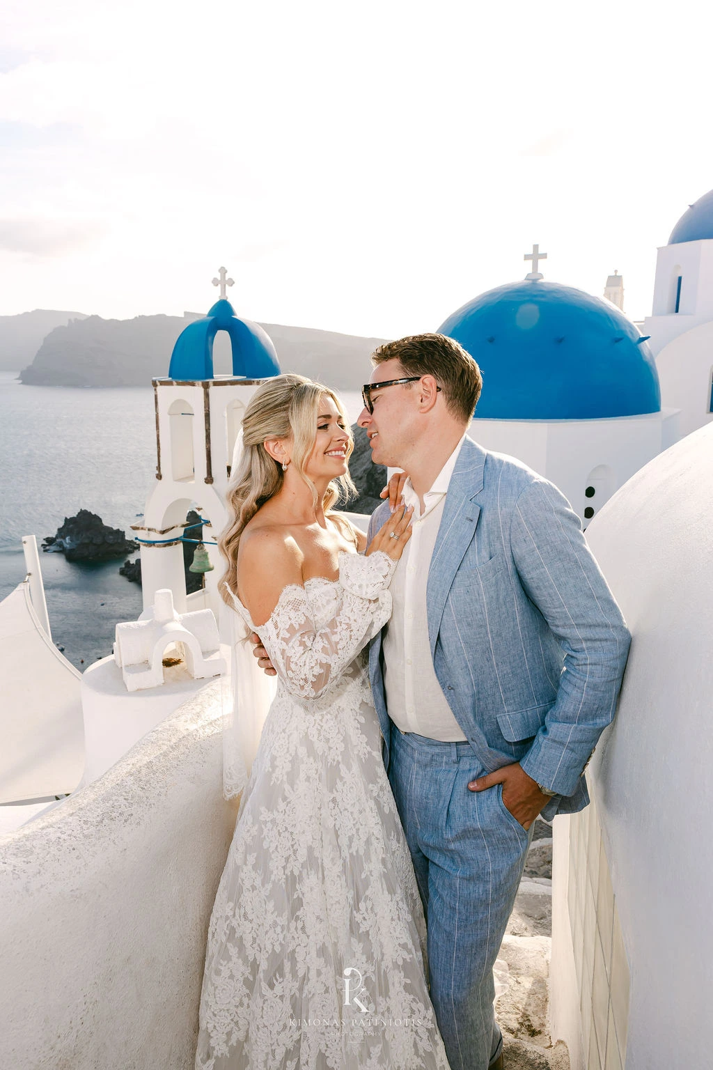 Greek Orthodox Wedding in Santorini - the couple in front of a blue dome - Marvellous Wedding
