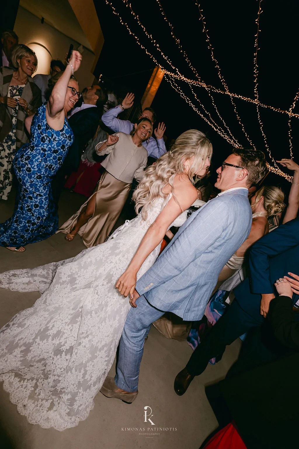 Greek Orthodox Wedding in Santorini - the couple is dancing in their wedding reception - Marvellous Wedding